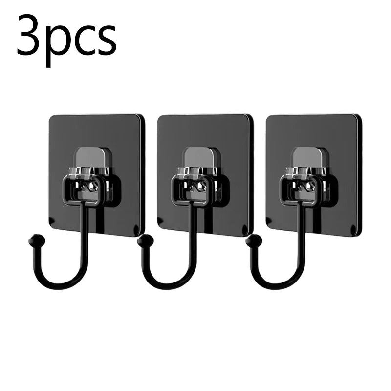Three black adhesive hooks with metal clasps and hanging wires for kitchen or bathroom storage