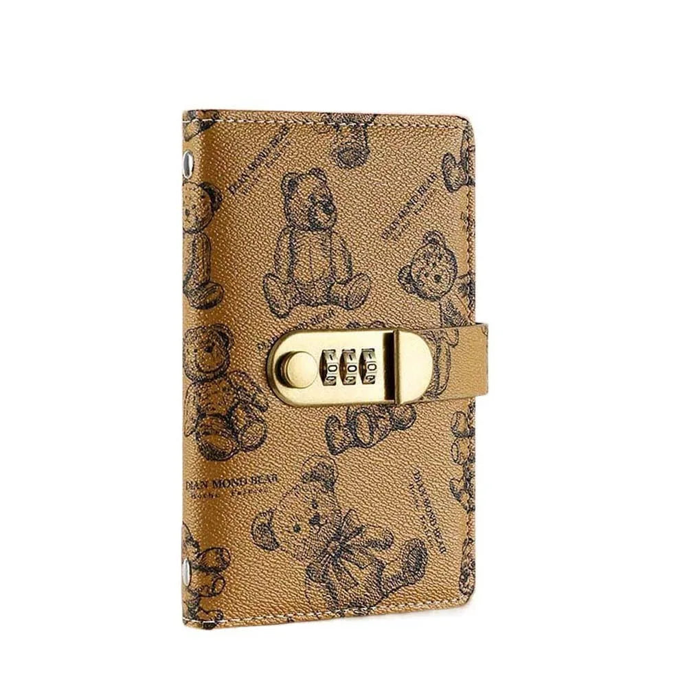 A gold-toned A6 cash budget organizer featuring a cartoon bear design and a lock.