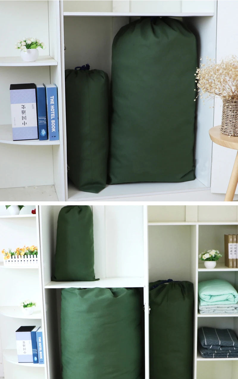 A white shelf unit displaying several dark green heavy-duty canvas laundry bags.