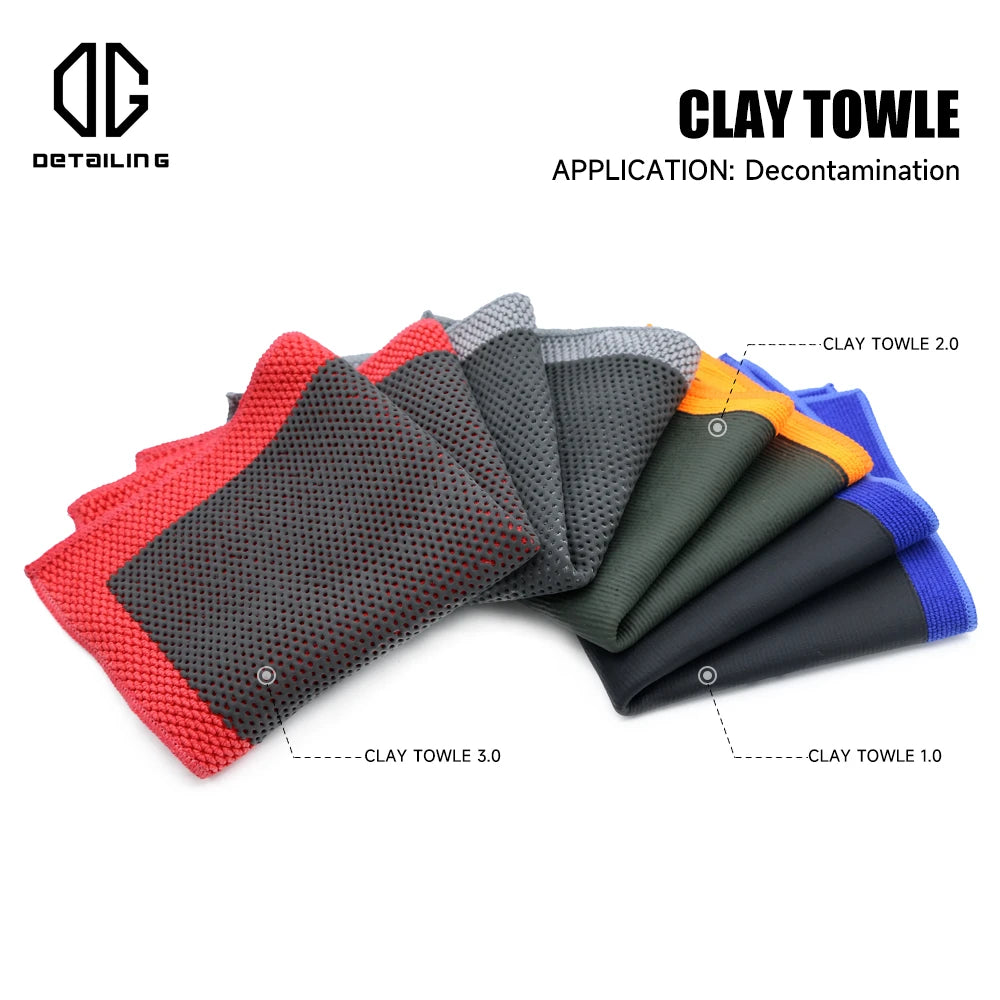 A collection of clay towels in various colors including red, gray, orange, and blue, used for paint decontamination.