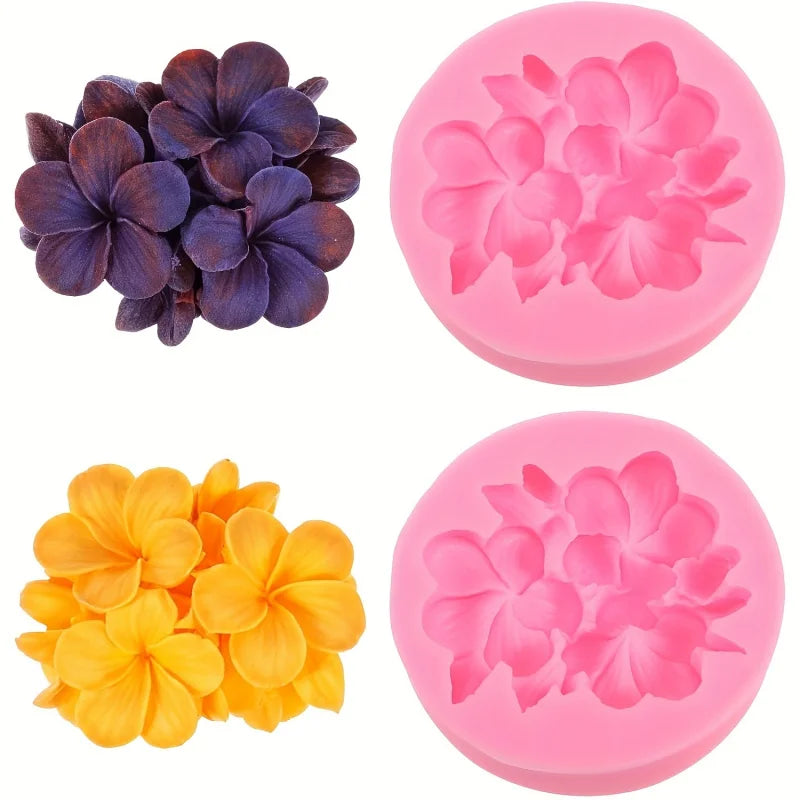 A set of three silicone floral molds in purple, pink, and orange colors for crafting.