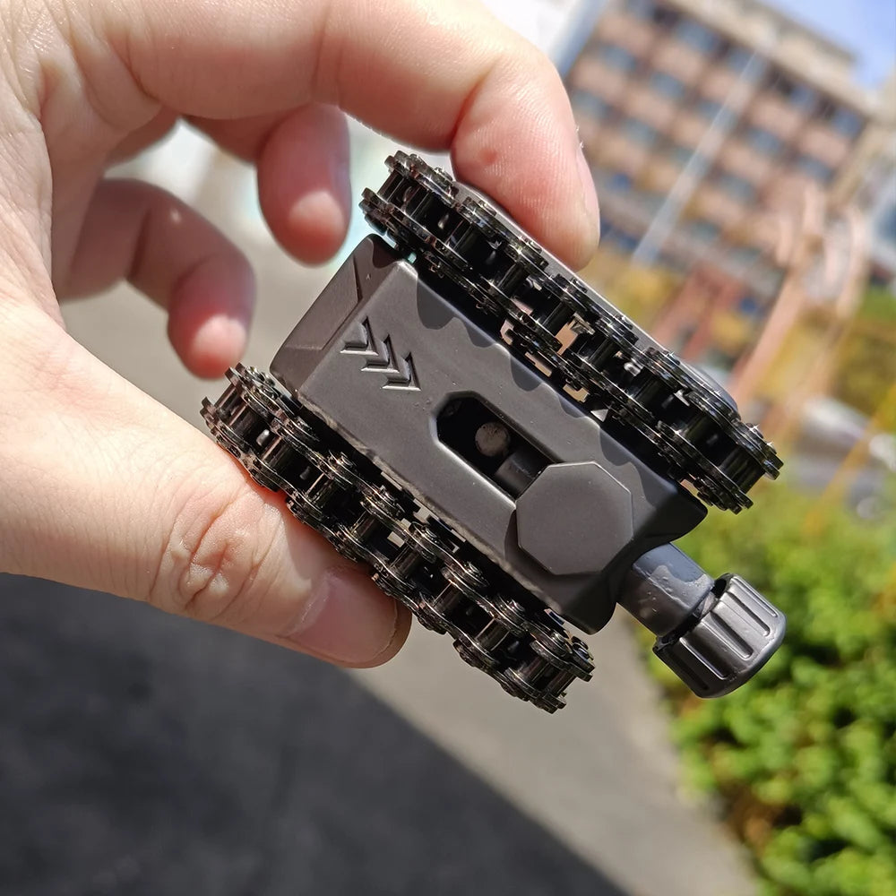 A hand holds a metal tactical tank fidget spinner with a rotating turret, showing its detailed gears and construction.
