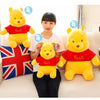 A woman is holding a yellow Winnie the Pooh plush toy, with size markers indicating 35, 45, and 55 cm.