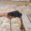 A hand holds an auto retracting strap storage device with a black strap attached.