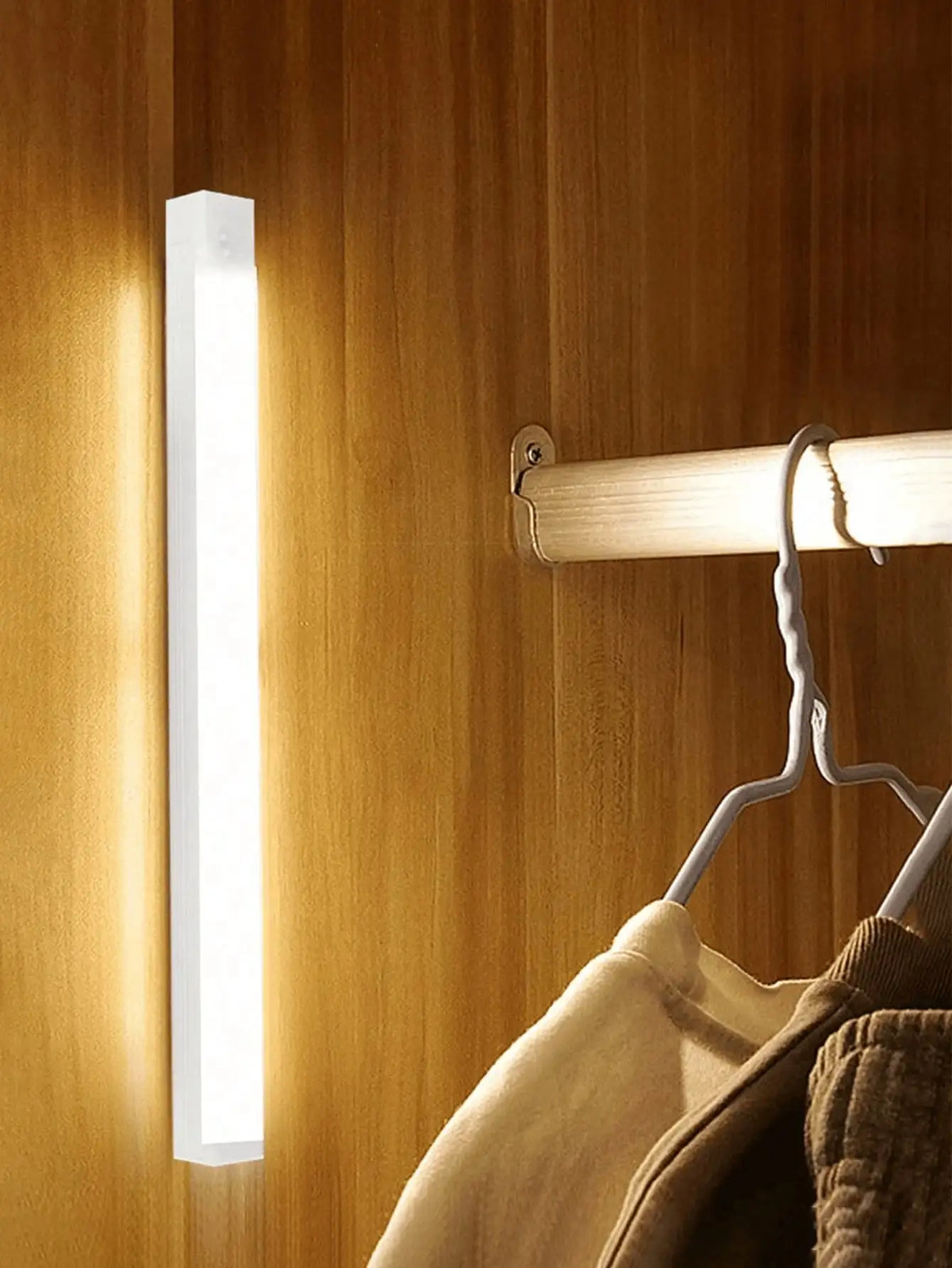 A vertical white LED night light is mounted on a wooden wall, illuminating the area.