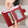 A hand is opening a maroon crocodile-embossed PU leather bifold wallet displaying credit cards and an ID.