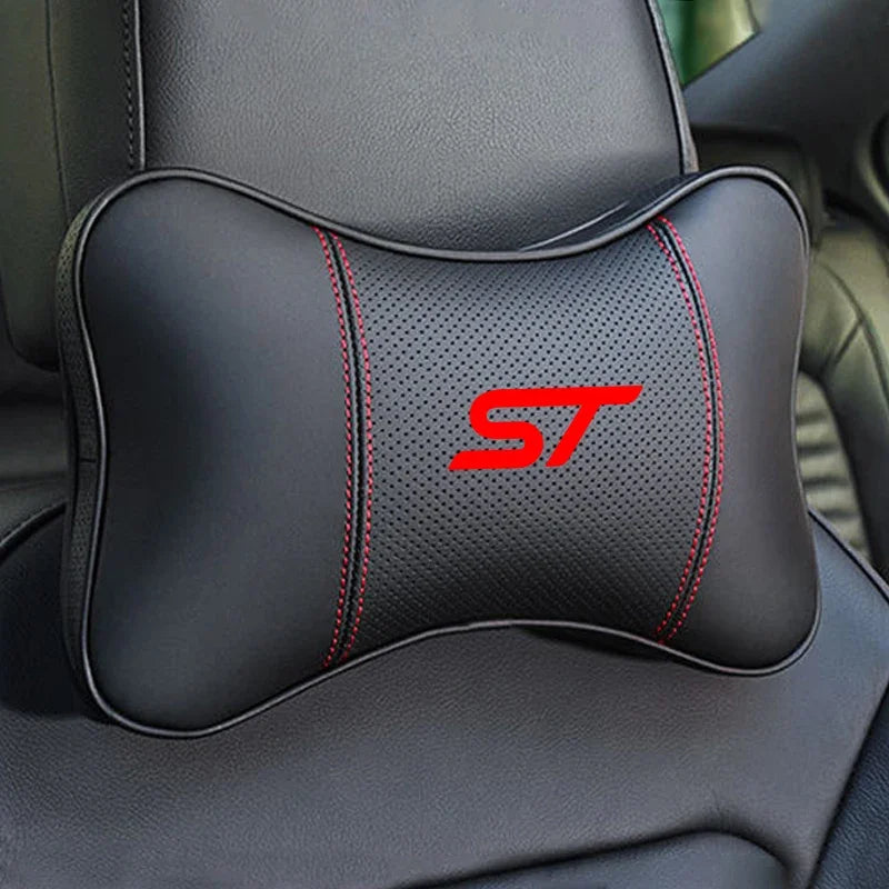 Black ergonomic car neck pillow with red stitching and an ST logo on a dark gray car seat.