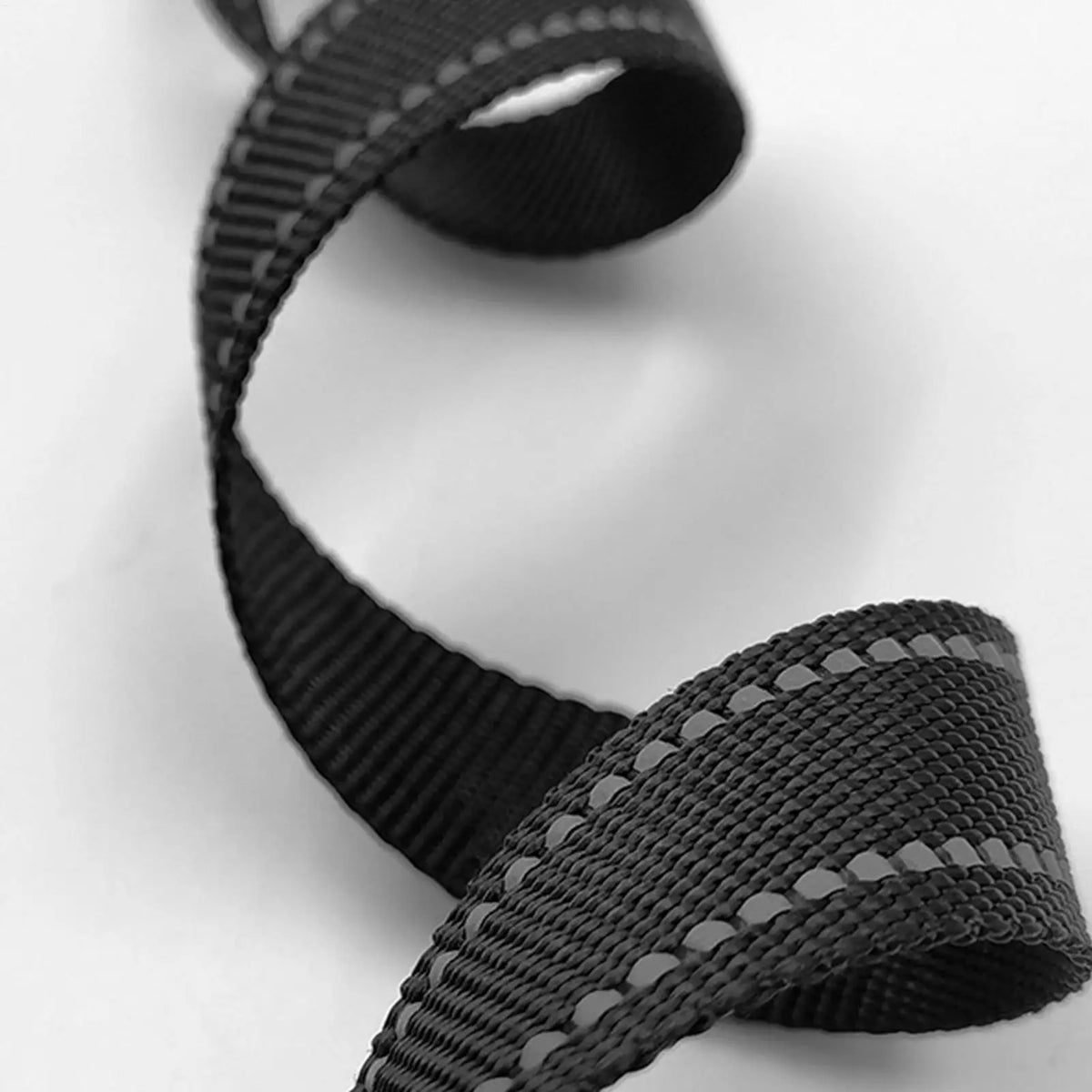 A close-up view of two black heavy duty ratchet tie down straps.