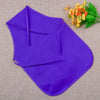 Purple non-woven fabric craft apron laid flat on a beige surface with a sprig of yellow flowers.