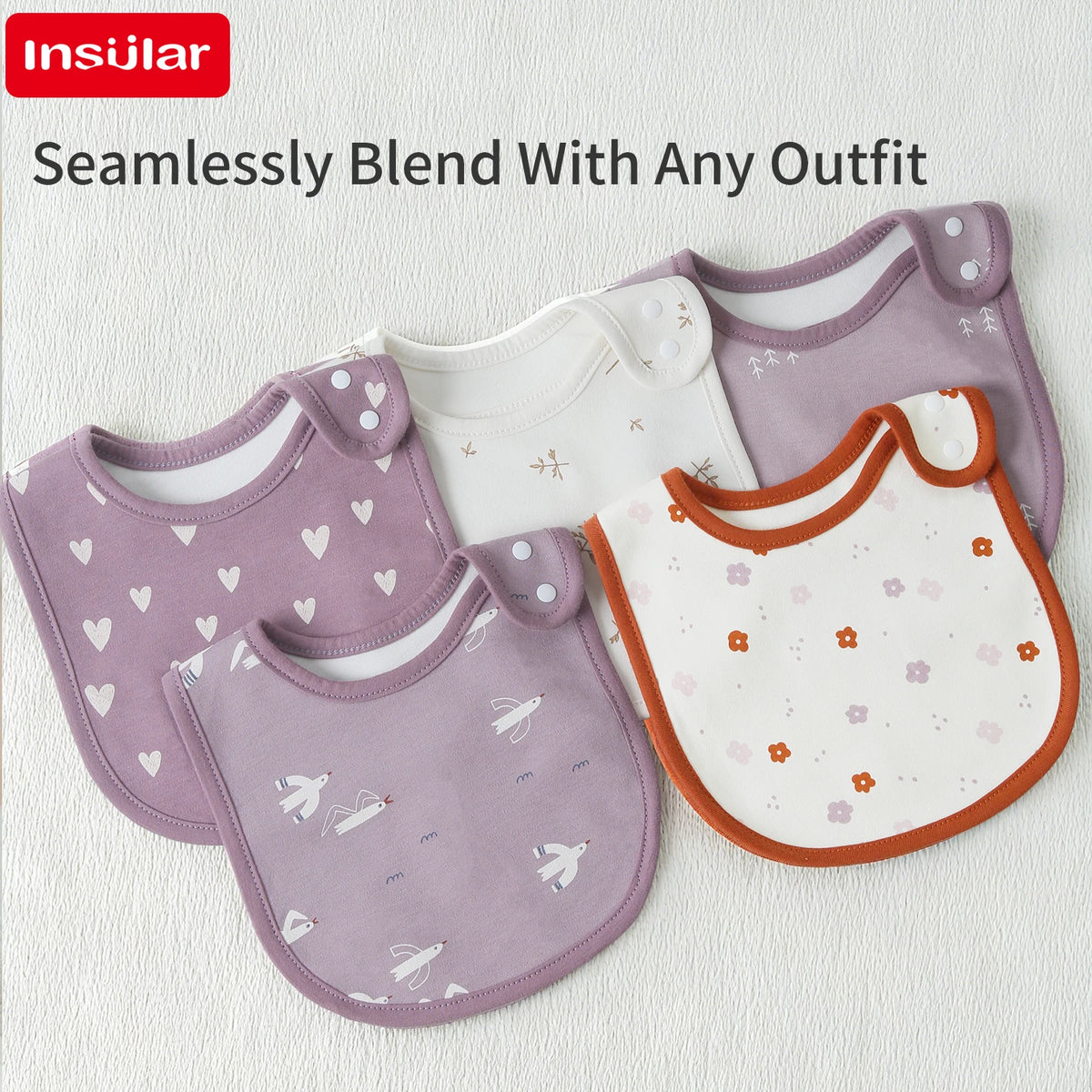 A set of seamless purple and white cotton baby bibs with floral patterns shown on a white background.