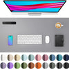 A computer monitor, a smartphone, a keyboard, a mouse, and various colored circles are displayed on a gray desk pad.