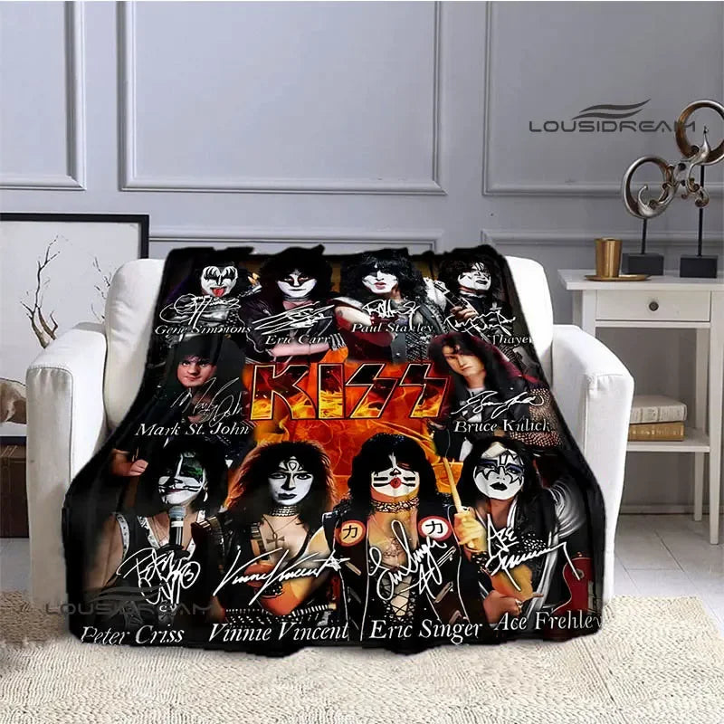 A black and orange printed flannel throw blanket featuring images of the Kiss band members.