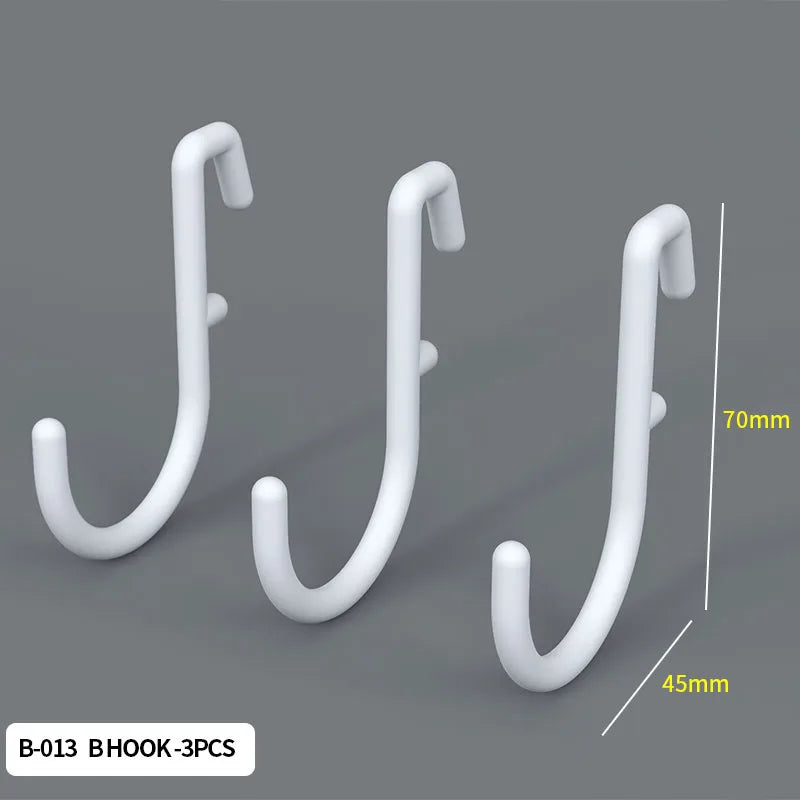 Three white hook-shaped organizers or hooks shown against a gray background.