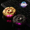 A close-up of a gold and purple magnetic fidget spinner resting on a black keyboard.