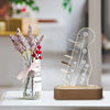 Illuminated acrylic guitar pick holder with a wooden base and dried lavender flowers