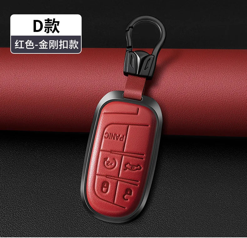 A red leather and metal key fob attached to a black keyring, shown against a dark background.