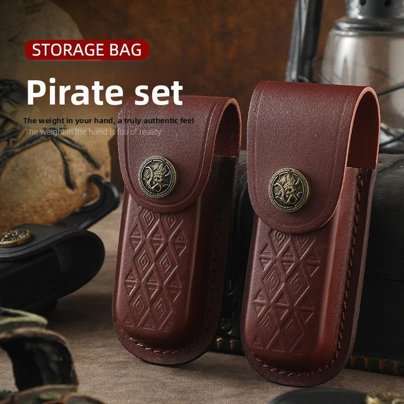 A pirate set of brown leather folding knife cases with brass accents displayed on a dark surface.