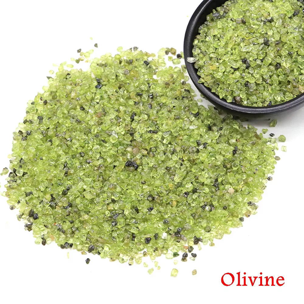 A pile of green olivine crystal stone chips in a black bowl.