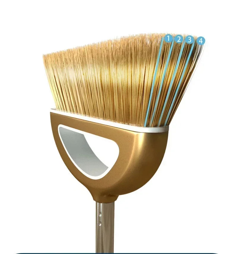 A close-up view of a golden broom with four bristles and a handle.