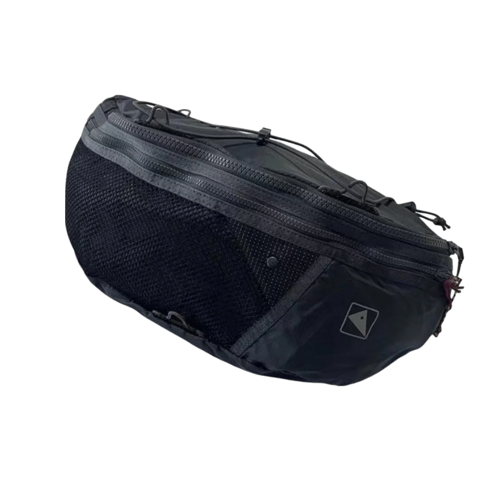 A dark gray nylon crossbody bag with a mesh front and adjustable strap, shown from the side.