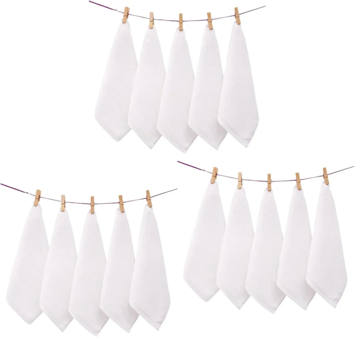 A set of white soft cotton terry cloth face towels hanging on a line.