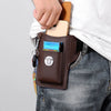 A brown leather waist bag is shown being held by a hand, featuring a slot for a phone and various accessories.
