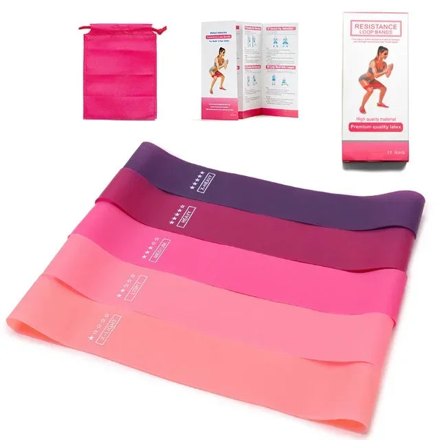 A set of pink and purple resistance bands for fitness and yoga, shown alongside instructional sheets.