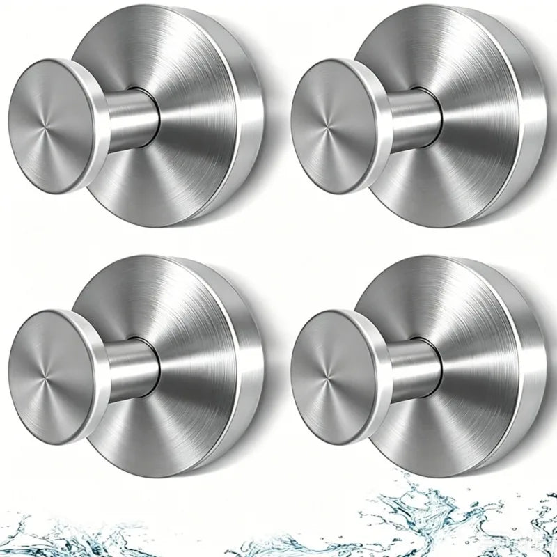 A set of two round, brushed stainless steel suction cup hooks shown from different angles.