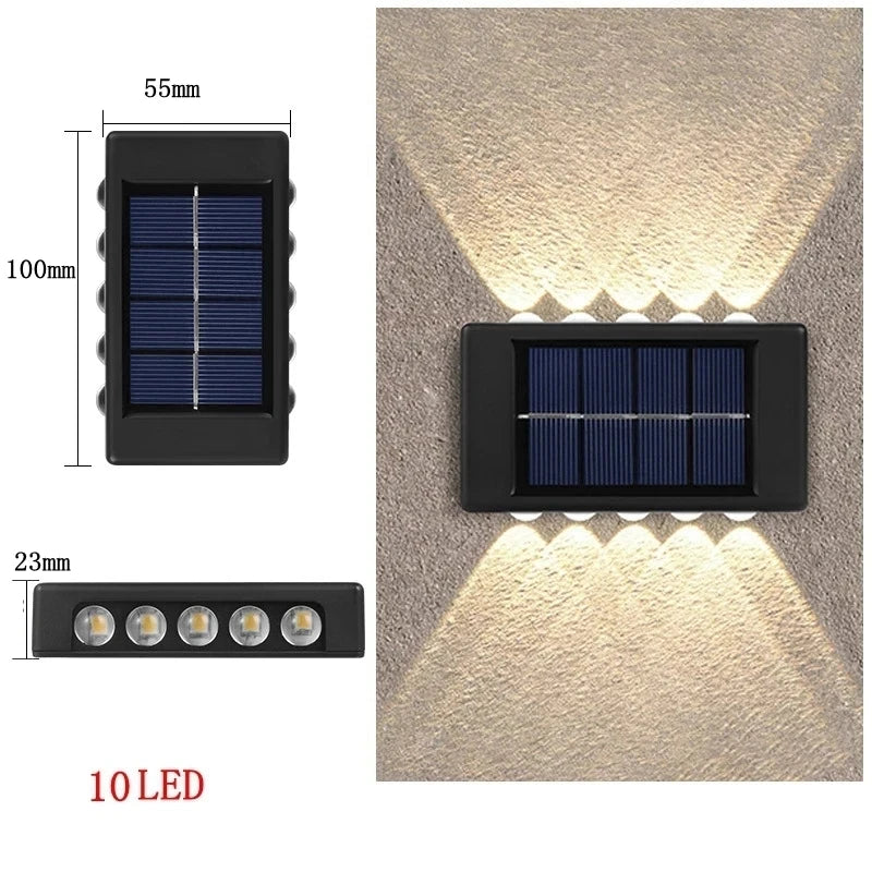 A black solar-powered LED wall light with a solar panel and 10 LEDs illuminating a textured wall.