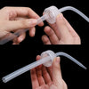 Hands hold clear plastic tattoo squeeze bottles with precision tips