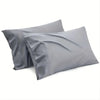 Two gray microfiber pillows or bed sheets laid flat against a white background.
