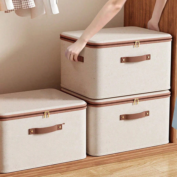 Una caja organizadora plegable con cremallera beige claro sobre un suelo de madera.