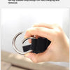 A hand is demonstrating a spring-loaded loop design for easy hanging and removal on an adjustable travel luggage strap.