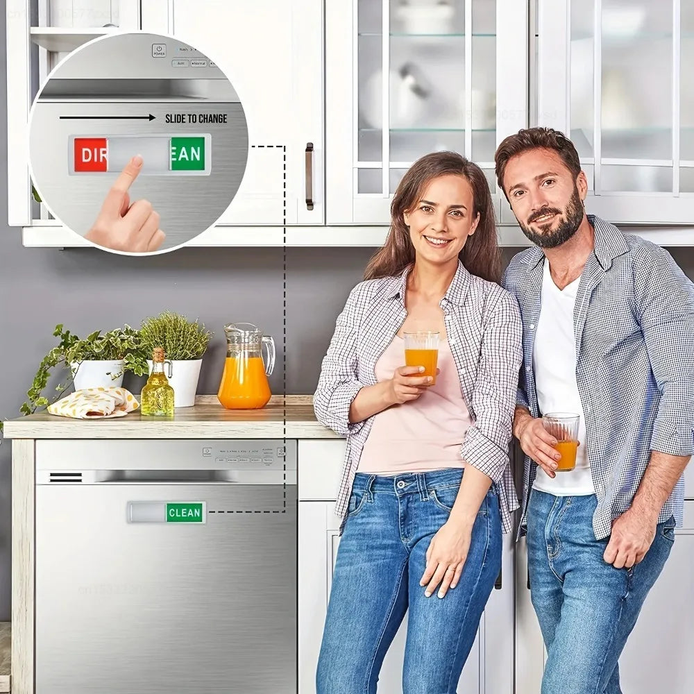 A woman and a man stand in front of a kitchen cabinet showing a dishwasher magnet sign for cleaning status.