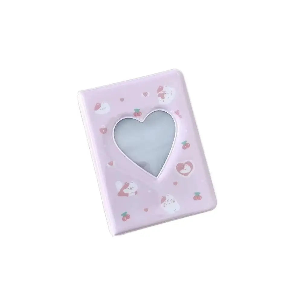 A square pink photo album with a heart cutout for 3-inch photos and cards.