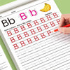 A child's hand is tracing the letter Bb on a worksheet for handwriting practice.