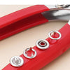 A close-up view of a red snap fastener pliers kit with metal buttons for DIY projects.