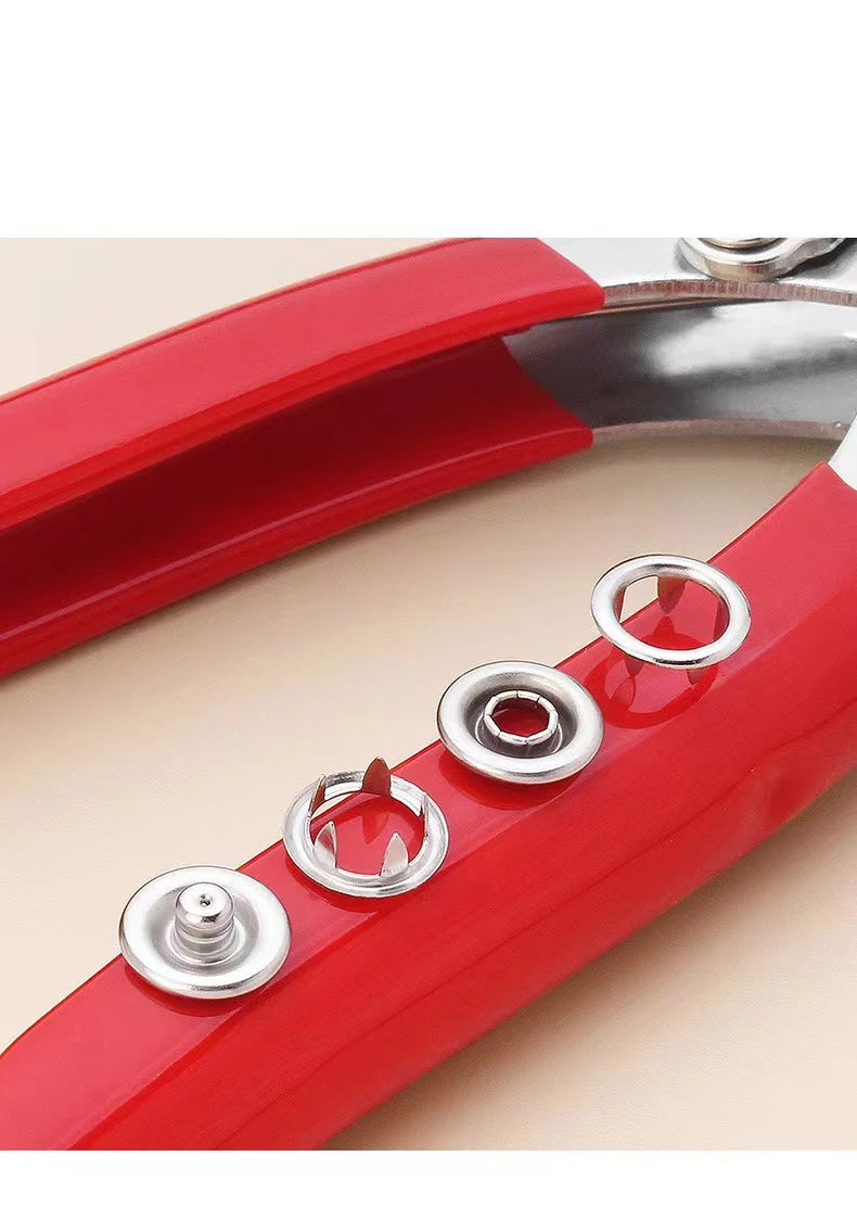 A close-up view of a red snap fastener pliers kit with metal buttons for DIY projects.