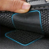 Close-up of heavy-duty black hook-and-loop tape being used to secure a car mat or rug.