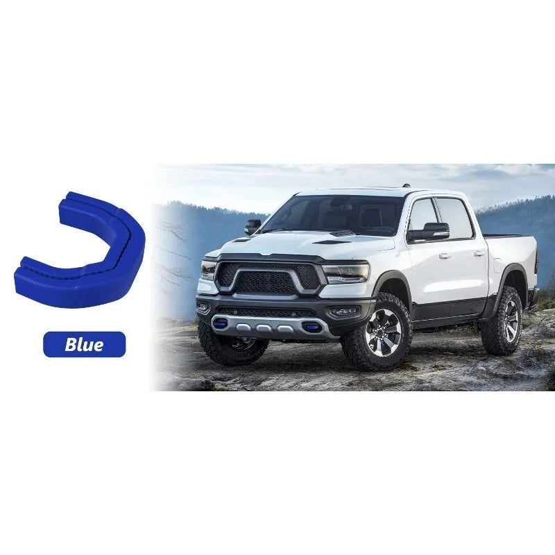 Blue front tow hook covers for a white RAM 1500 pickup truck.