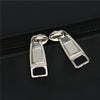 Silver zipper pulls attached to a black duffel bag