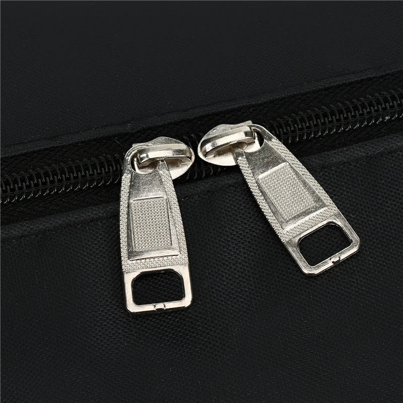 Silver zipper pulls attached to a black duffel bag