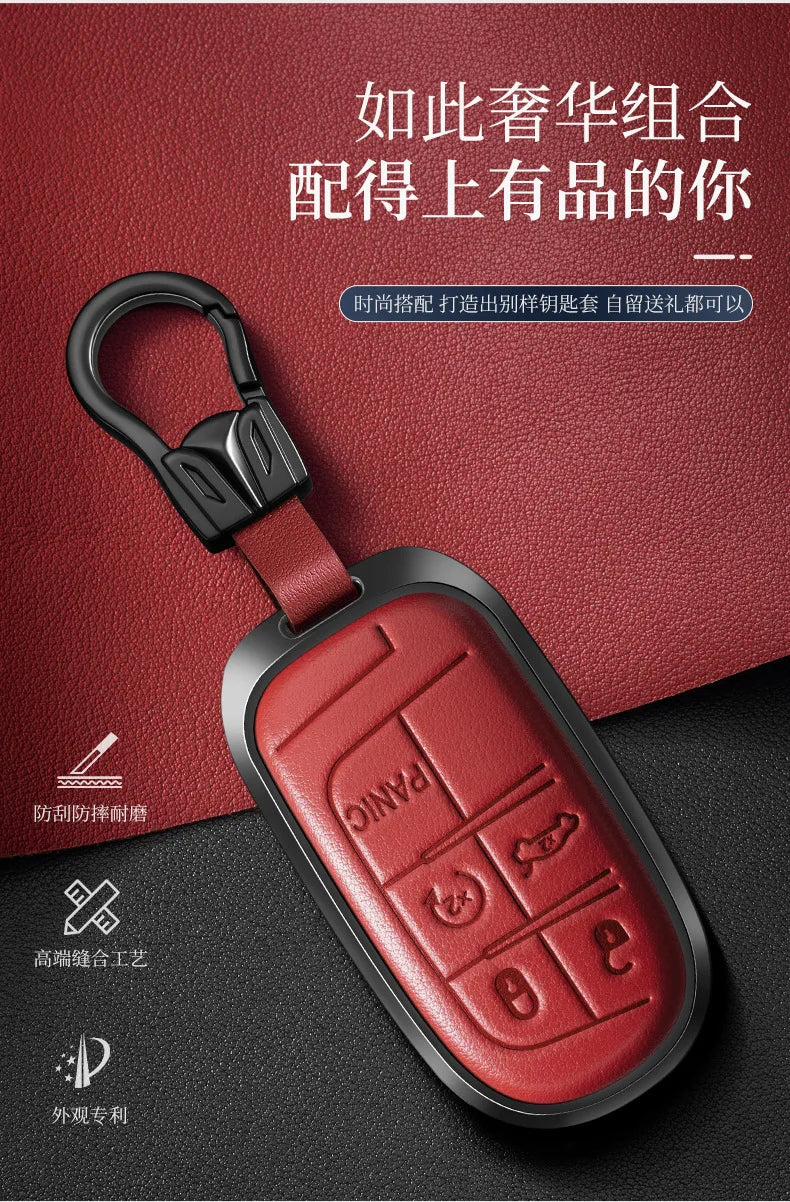 A red leather and metal car key case with a black lanyard attached, featuring a panic button design.