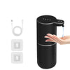 A black touchless automatic soap dispenser is shown with a hand dispensing liquid soap.
