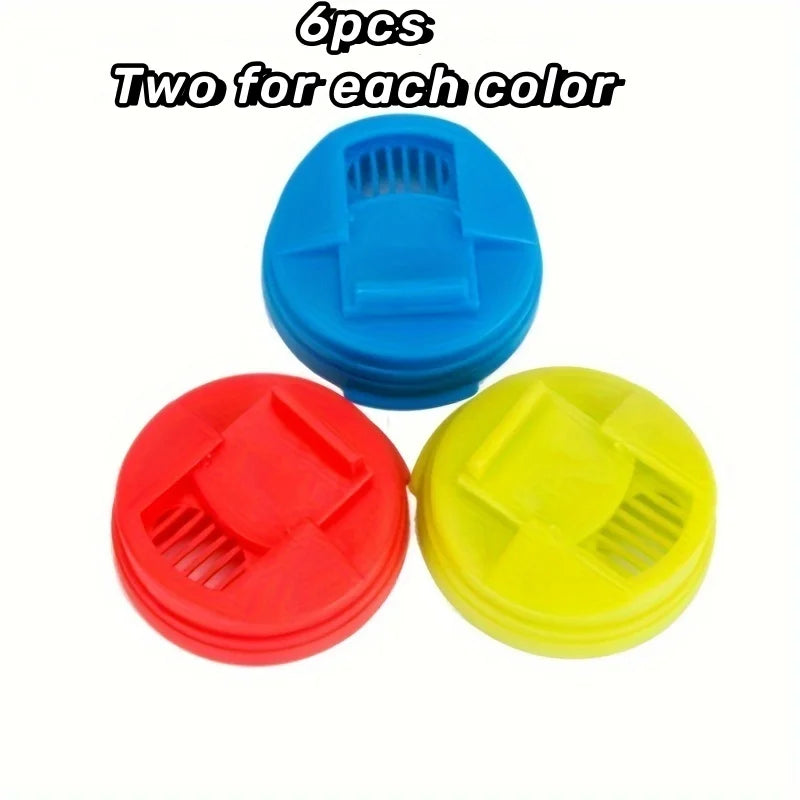 Three colorful reusable beverage can lids in blue, red, and yellow.