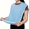 Light blue adjustable flannel bib worn by a person for elderly or disabled care.