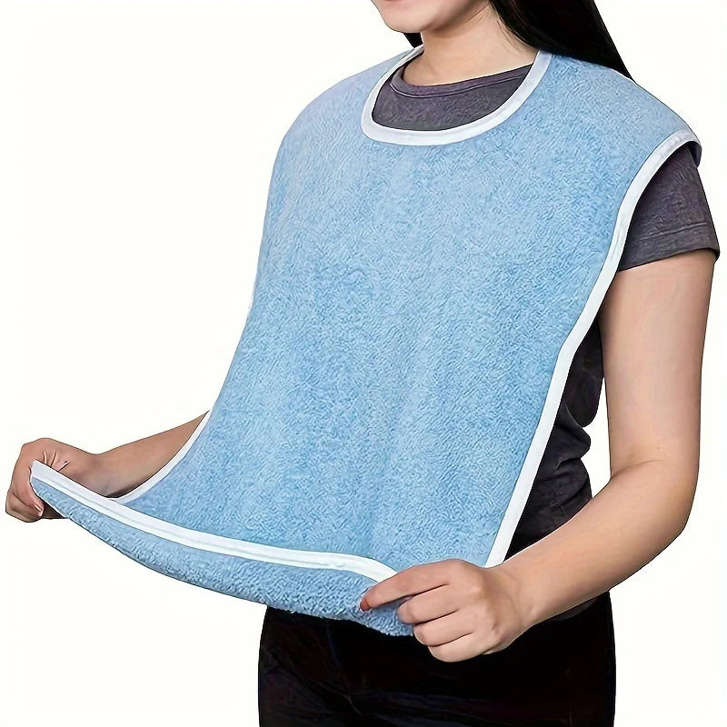 Light blue adjustable flannel bib worn by a person for elderly or disabled care.