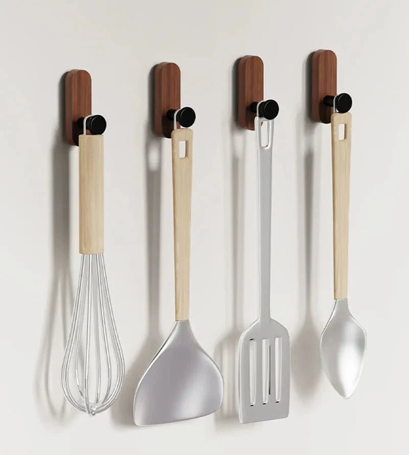A set of self-adhesive walnut wood hooks with silicone tops for entryway and bathroom organization.