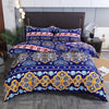 A vibrant blue and gold patterned duvet cover set with matching pillowcases displayed on a bed.
