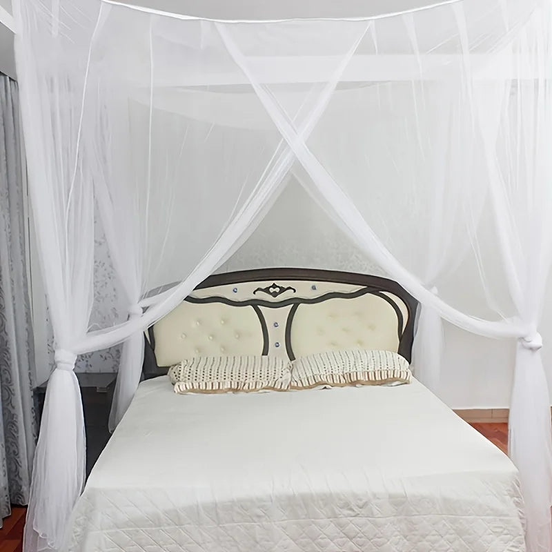A white mosquito net draped over a bed, featuring double openings and sheer fabric.